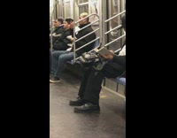 Man bites off apple skin and spits it out onto napkin on subway