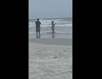 Woman black bikini fringe dance beach