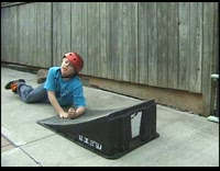 Boy on skateboard falls on the ramp