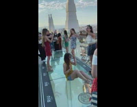 Girl sit transparent glass floor rooftop party