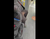 Man with piss stains on pants train