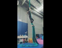 Woman climb silk and do drop trick