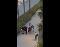 Woman backless dress crowd photo shoot beach