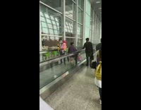 Woman walk opposite direction airport flat escalator