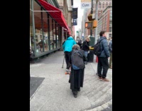 Man on skateboard use trekking pole to move