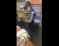 Man with box of tools and popsicle stick crafts on subway train 