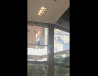 Guy golden hair flip blue shorts balcony