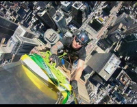 Guy climbs up tall part of building 
