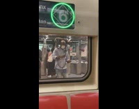 Guy runs to train with grey dog on his shoulders 