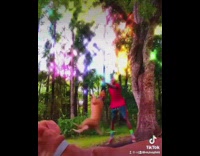 Guy spins dog hanging onto rope toy