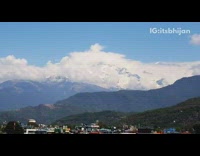 Time lapse white clouds cover snow mountain 