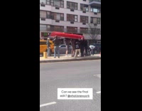 Guys carry red boat upside down on street
