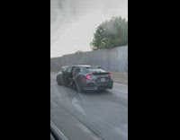 Shirtless guy in back of car with door open wiping it down