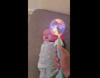Baby lie down stops to cry with light stick toy