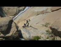 five guys slide down rock into water