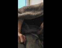 Guy sleeps on couch cat under blanket