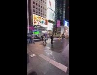 Woman long grey jacket dance times square