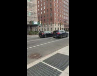 Person wears inflatable pink flamingo costume sidewalk 