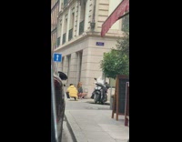 Woman gray jacket squat butt flex sidewalk