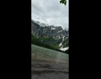 Guy brown boots sit lake west glacier