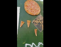 Pizza and three slices attached to fence 