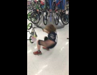 kid rides a small green bike and falls back