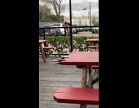 Girls walk toward guy in parking lot 