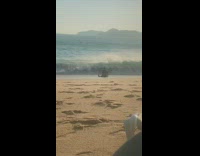 Man sits wait big ocean wave beach