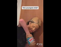 girl covers face in skippy peanut butter