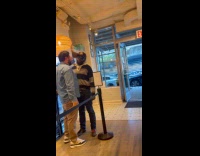 Two men argue and fight inside shop