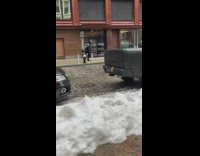 Guy walking down sidewalk wears black cape