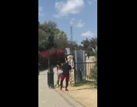 Shirtless guy show leg muscles metal gate