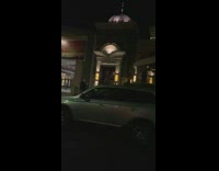 Girl takes photo outside of cheesecake factory