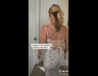 Woman shows her husband her new dress