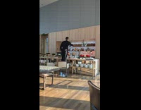 Guy stands on chair to take photo