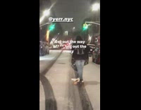 Man on Scooter Rides at Street on Snowstorm