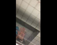 Subway train worker in orange vest fixes train in the middle of tunnel seen outside window