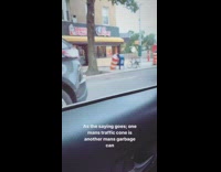 Upside down giant orange traffic cone turns into a trash can on sidewalk