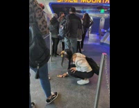 Two girls in line take ground selfie 
