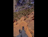 Man Stands on Cliff Edge to Show View