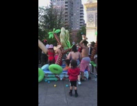 Group of people fight in inflatable pool at park with floaties 