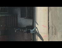 Guy walks down sidewalk while holding bird 