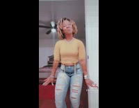 Woman does Tik Tok dance in bedroom 