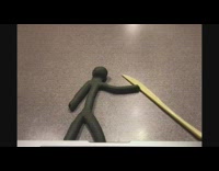 Clay guy rides surf board 