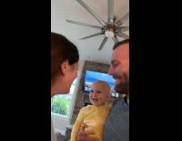 Baby see parents kiss and then smiles