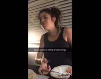 Black shirt girl eats salad chicken wings 