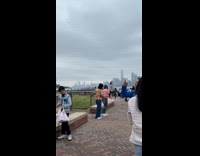 Two people dances front of Liberty statue