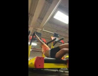 Girl in orange shirt trips and falls on yellow treadmill