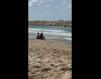 Drone fly over couple sit beach jetty