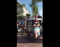 Line of people wait to take photo at beach southern most point of US